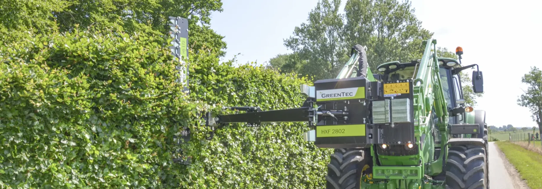 Hedge trimmer front mounted on tractor