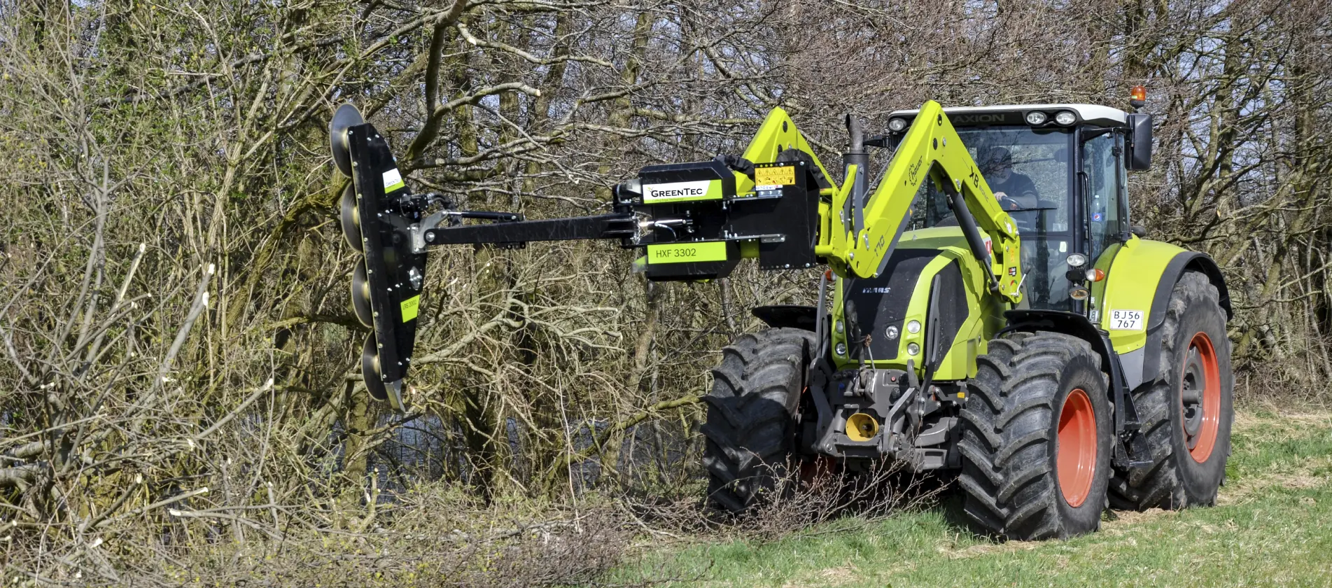 Tractor attachment for tree trimming