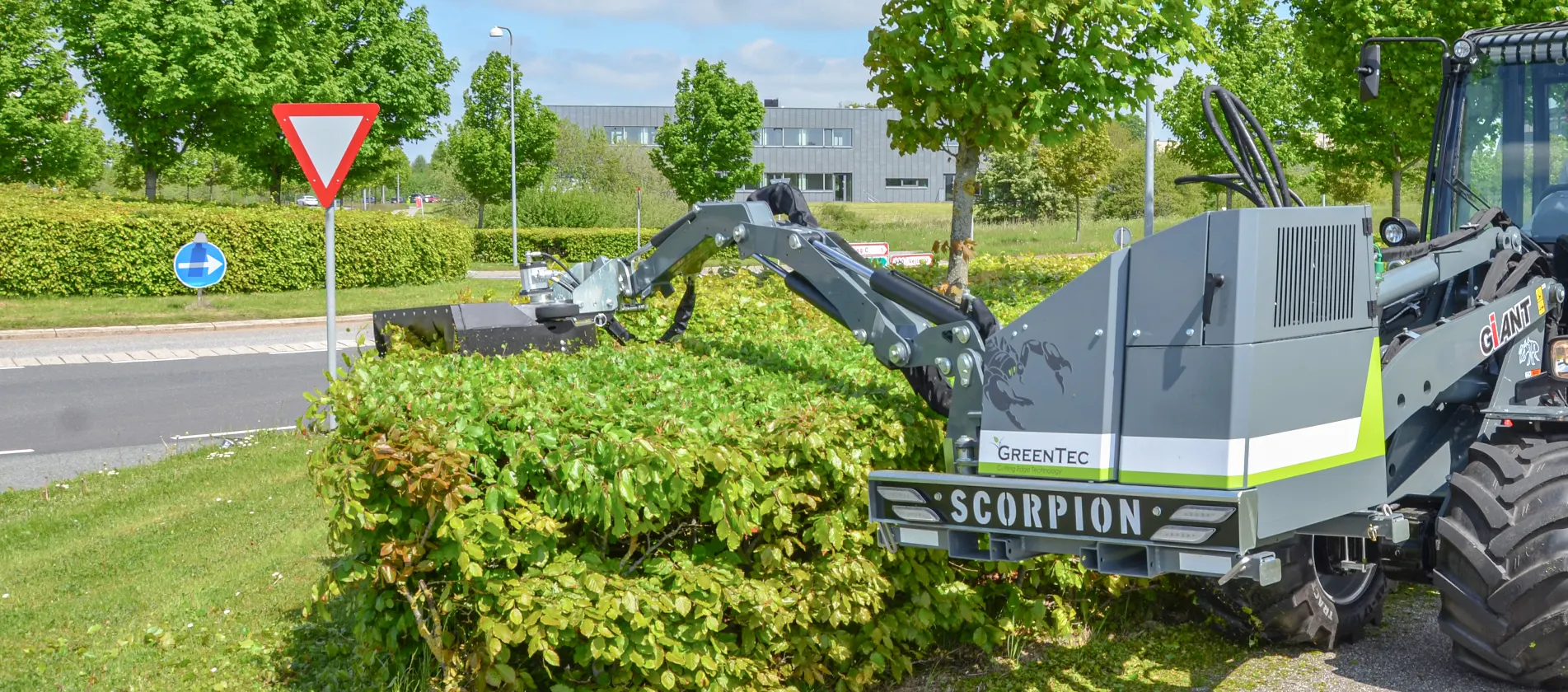Hydraulic hedge trimmer mounted on a Giant skid steer loader