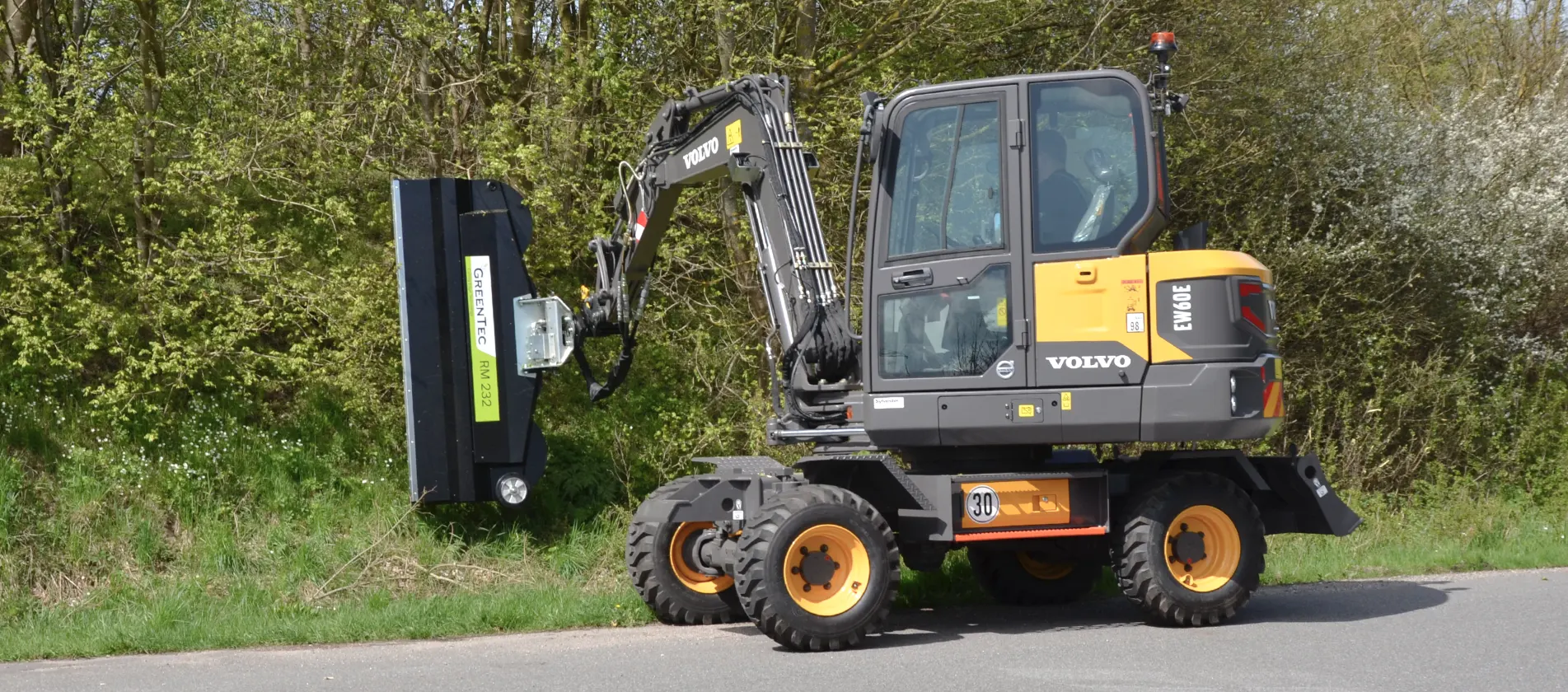 Hedge mulcher mounted on Volvo excavator