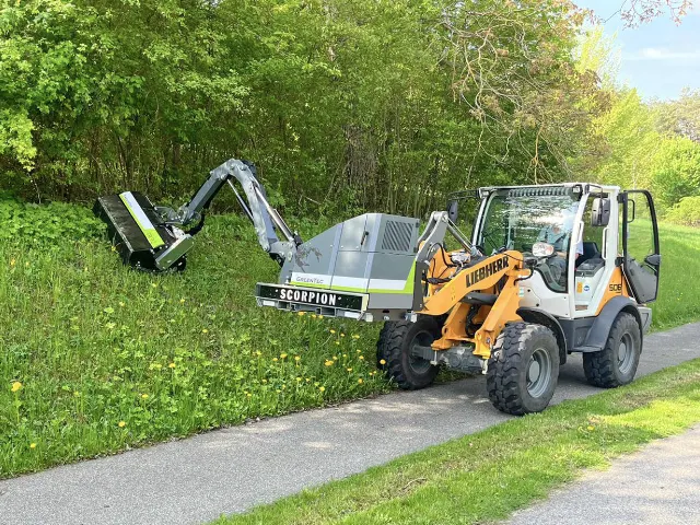 Slope mowing with boom mower arm