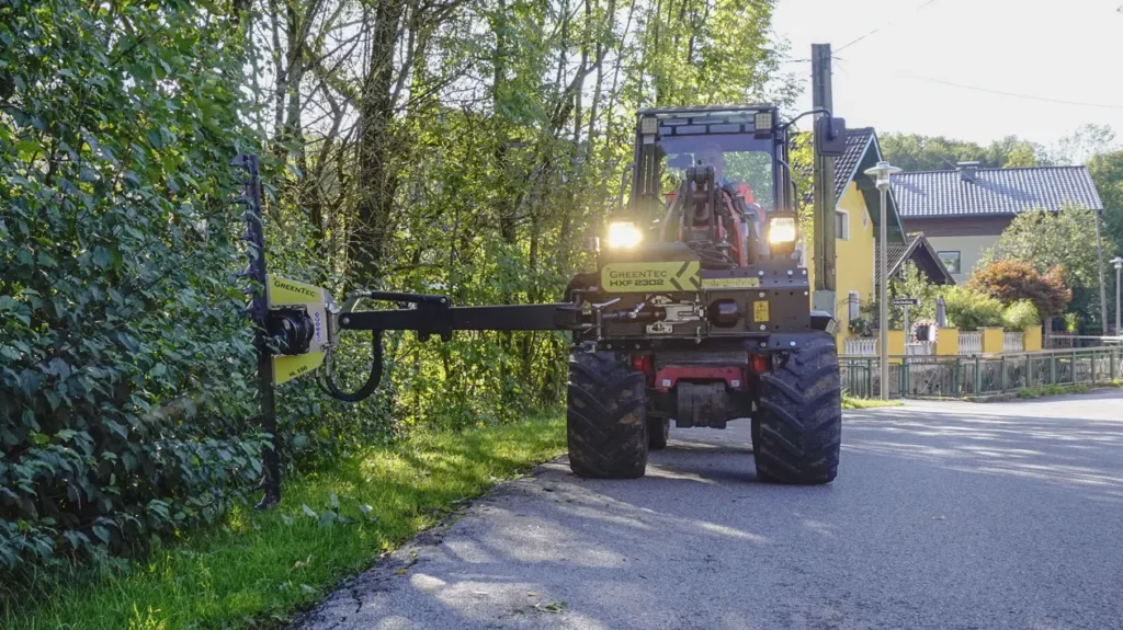 Municipal hedge cutting with skid steer loader