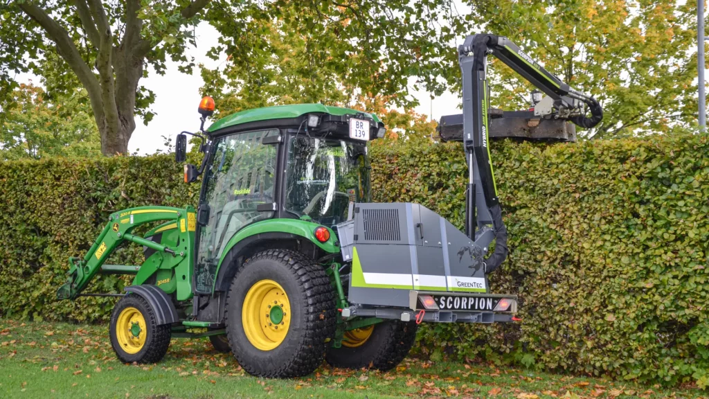 GreenTec boom mower mounted on John Deere 3045R compact tractor