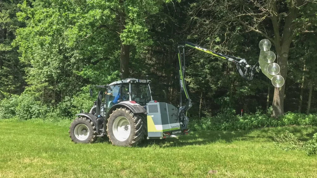 Tractor mounted boom mower with saw attachment