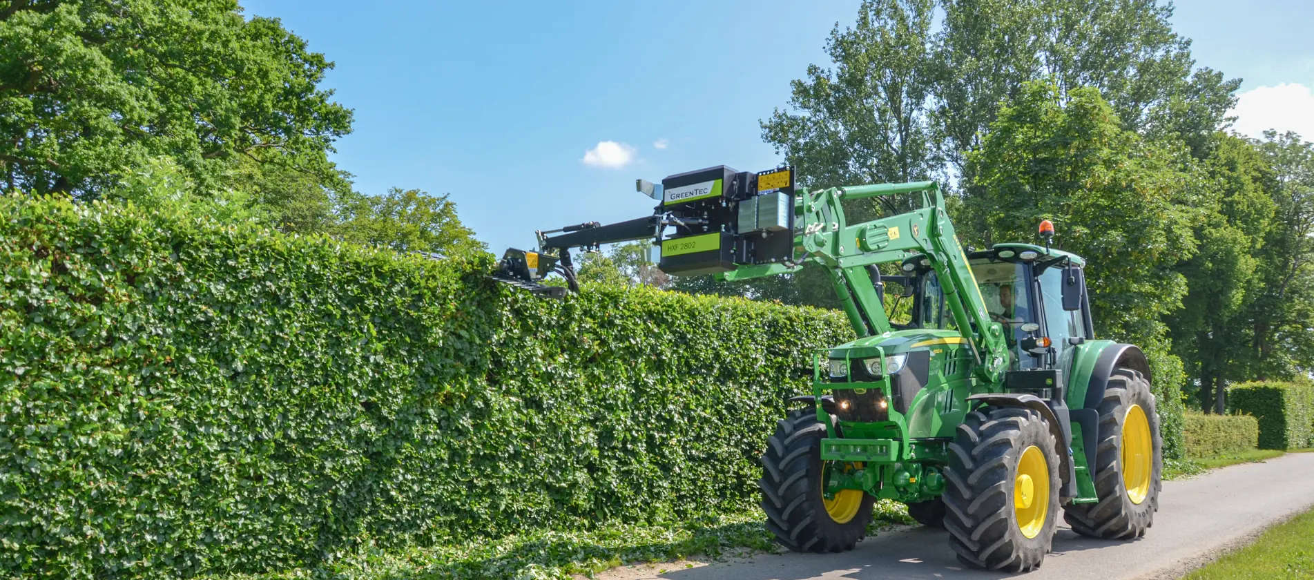 Hedge trimming with attachment frame mounted on front end loader